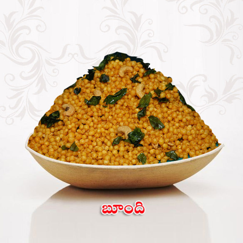 Crispy boondi snack served in a bowl with curry leaves and cashews by Athithi Gruha Foods