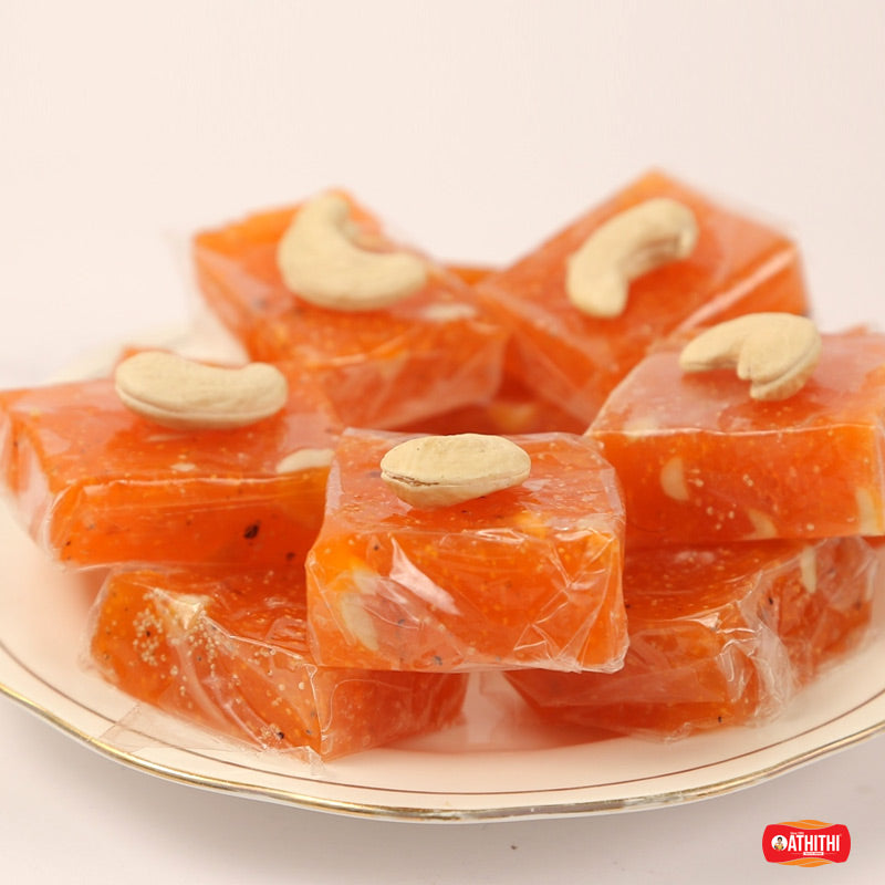 Bright orange Bombay halwa squares topped with cashew nuts, served traditionally by Athithi Gruha Foods in Andhra style