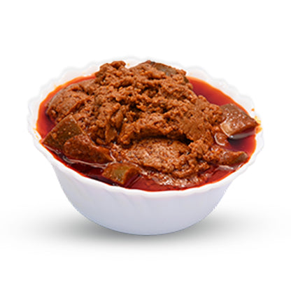 Bowl of Bellam Avakaya (Sweet Mango Pickle) with thick gravy and red oil.