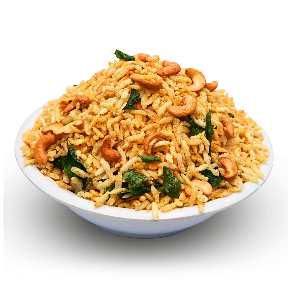 Bowl of fried rice with cashews and greens on a white background