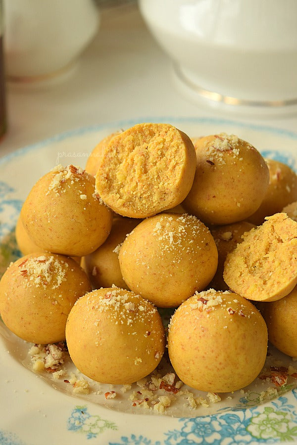 Freshly made Besan Laddu (Gram Flour Balls) garnished with almond and pistachio bits.