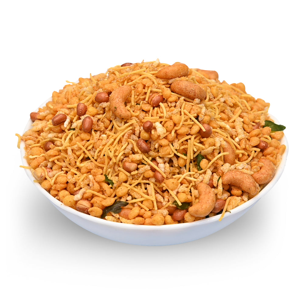 Bowl of crispy snack with cashews on a white background