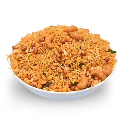Bowl of crispy snack with cashews on a white background