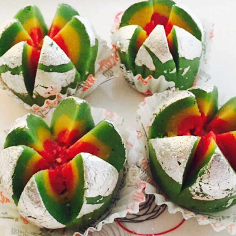 Authentic Cashew Flower mithai with silver leaf (vark) garnish, a specialty traditional Andhra sweet available from Athithi Gruha Foods.