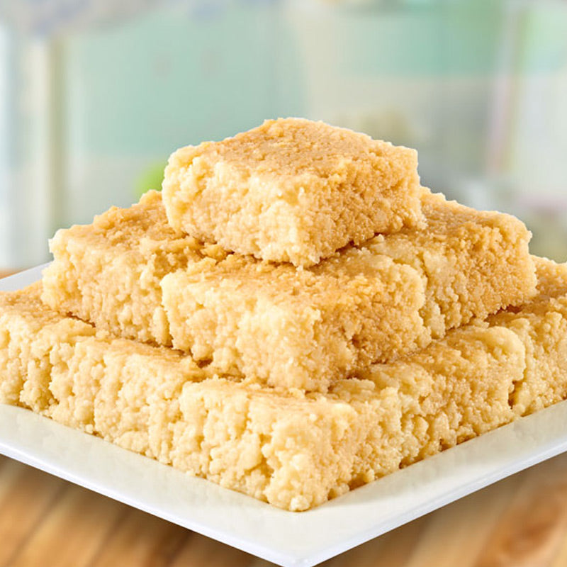 Fresh Cashew Kalakand (Kaju Kalakand) stacked on a plate, a traditional Andhra sweet by Athithi Gruha Foods.