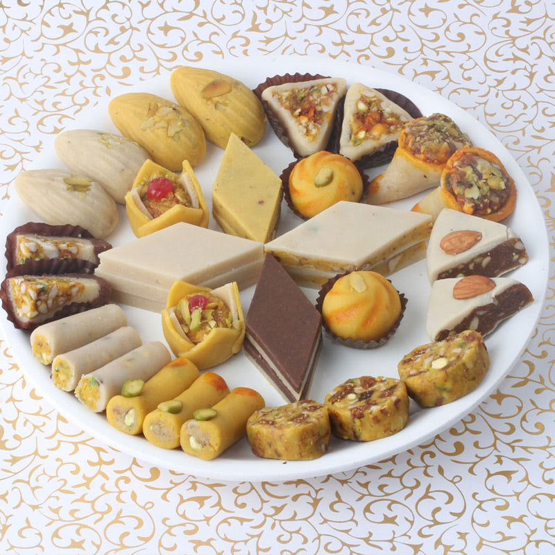 Variety pack of handcrafted Kaju Mithai including rolls and burfi, prepared in authentic Andhra style by Athithi Gruha Foods.
