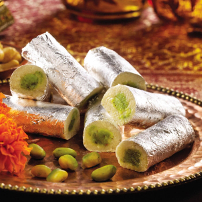 Silver-coated Cashew Rolls with a rich pistachio filling, a traditional Andhra style sweet by Athithi Gruha Foods.