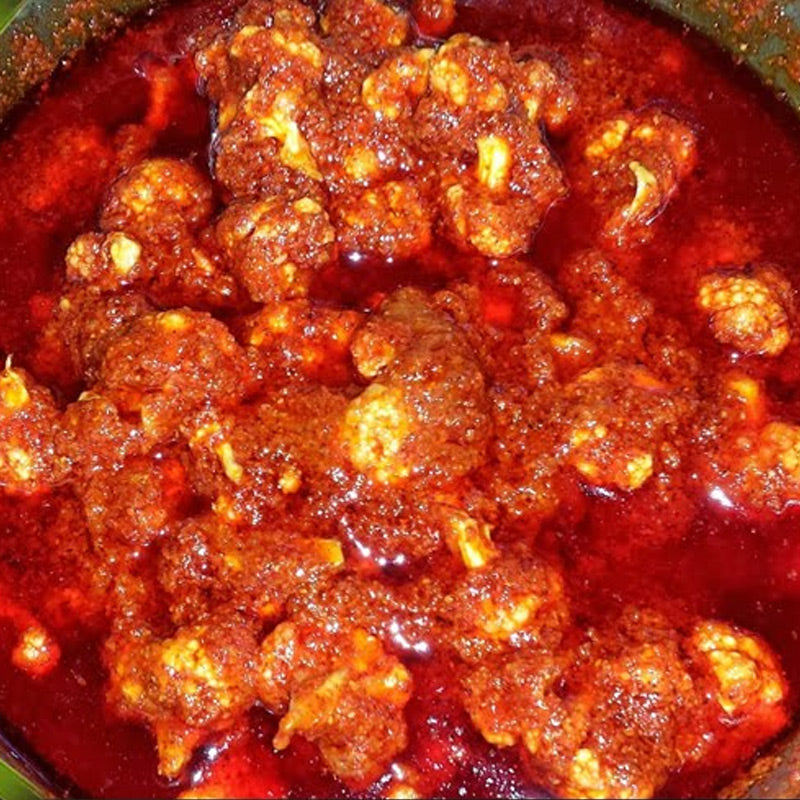 Spicy and tangy Cauliflower Pickle with visible florets and rich masala, handcrafted by Athithi Gruha Foods.