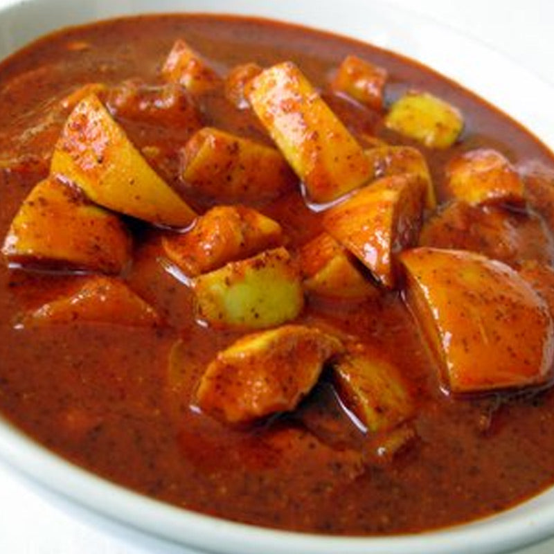 A bowl of Dosa Avakaya Pickle, the spicy condiment mixed with chopped potatoes and onions.
