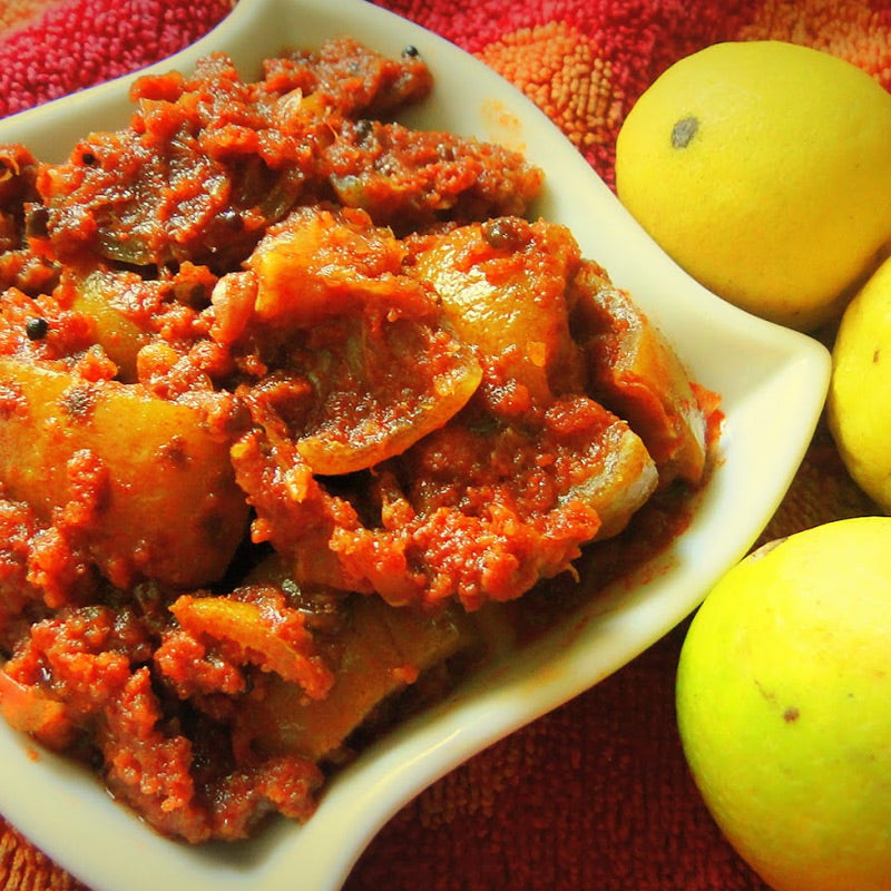 Spicy and tangy Andhra lemon pickle prepared with fresh lemons and traditional spices.
