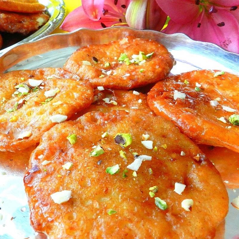 Traditional malpuri sweet deep fried and soaked in syrup, a festive Andhra dessert.
